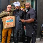 Chef Charles Gabriel and COO Quie Slobert pose outside the Harlem shop with a fan.